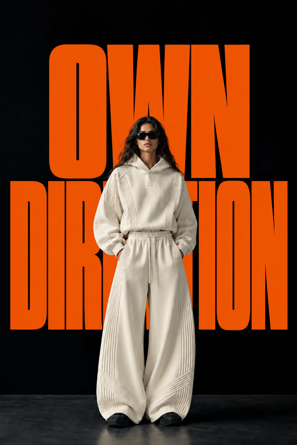 Original OWN DIRECTION campaign artwork featuring a woman in a light-coloured tracksuit in front of large orange lettering.
